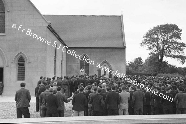 MEN AT CLOSING SERMON OUTSIDE THE CHURCH